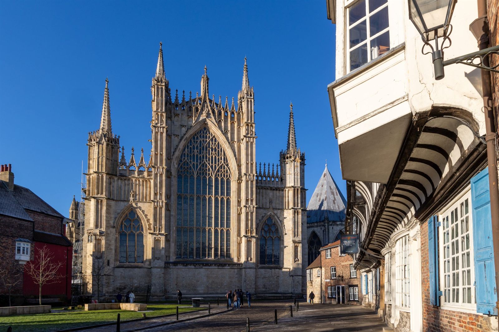 York Minster rising at the end of a street of old buildings with an overhanging bay window